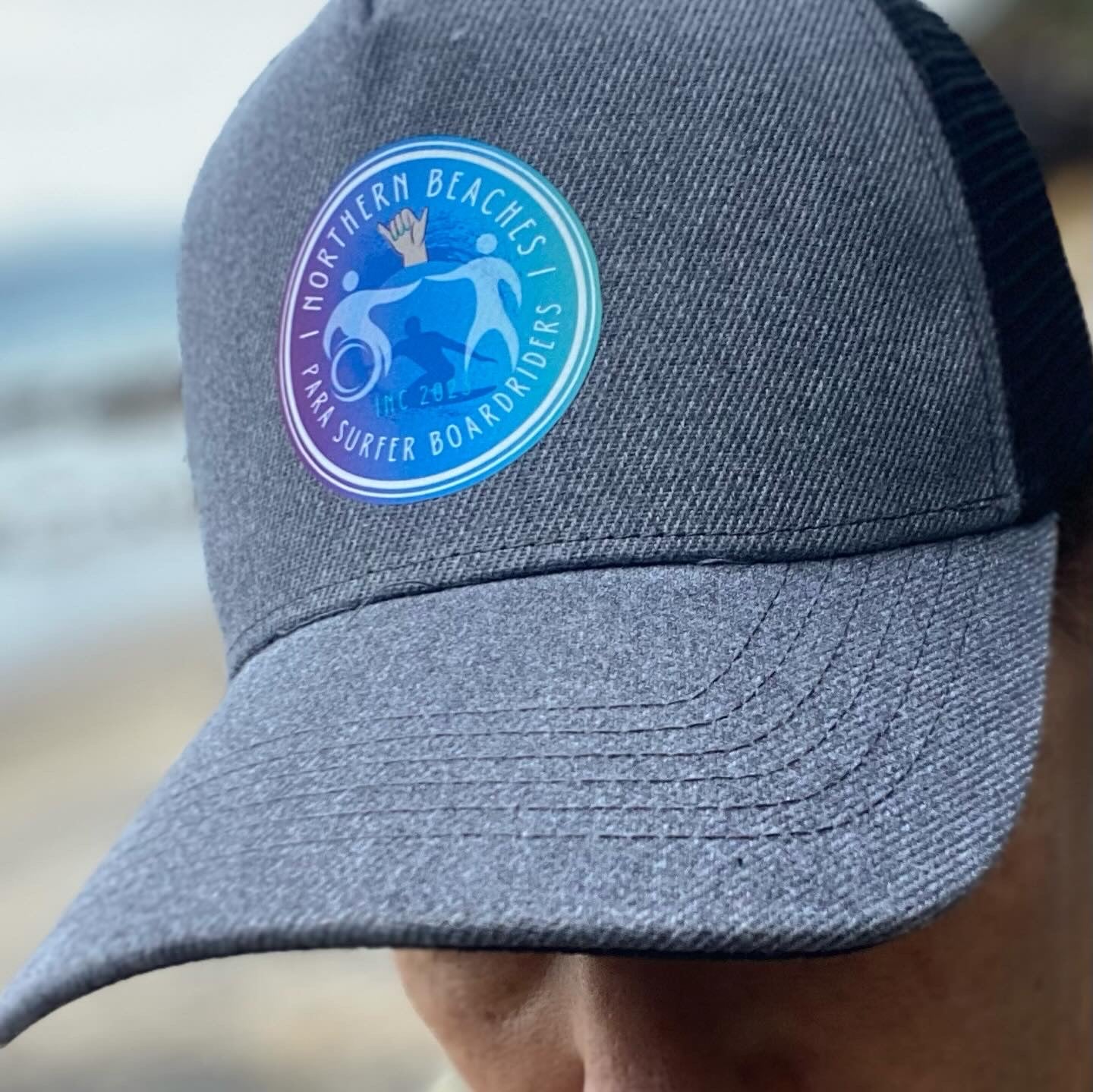 Charcoal and Black Trucker Styled Hat with NBPSB Club Logo on Front Centre. 